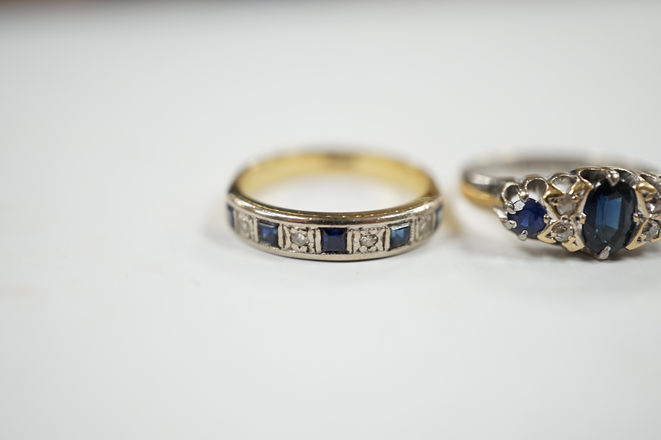 A George V 18ct white gold, sapphire and diamond cluster set ring, size K and one other 18ct, sapphire and diamond set half hoop ring, gross weight 7 grams.